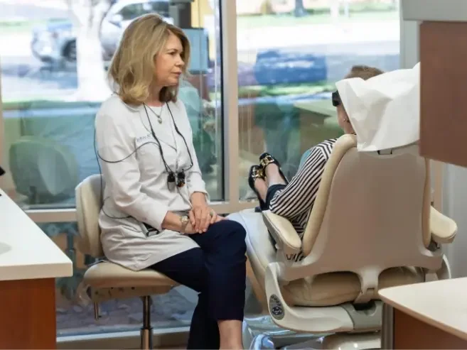 doctor laurie explaining implants to patient - Exceptional Dentistry doctor laurie explaining implants to patient