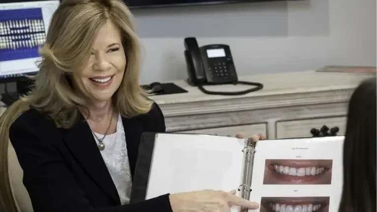 doctor laurie showing pictures of smiles - Exceptional Dentistry doctor laurie showing pictures of smiles