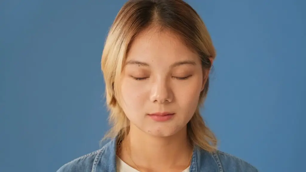 young-woman-dressed-in-denim-shirt-stands-with-her-2025-05-19-20-51-02-utc - Exceptional Dentistry
